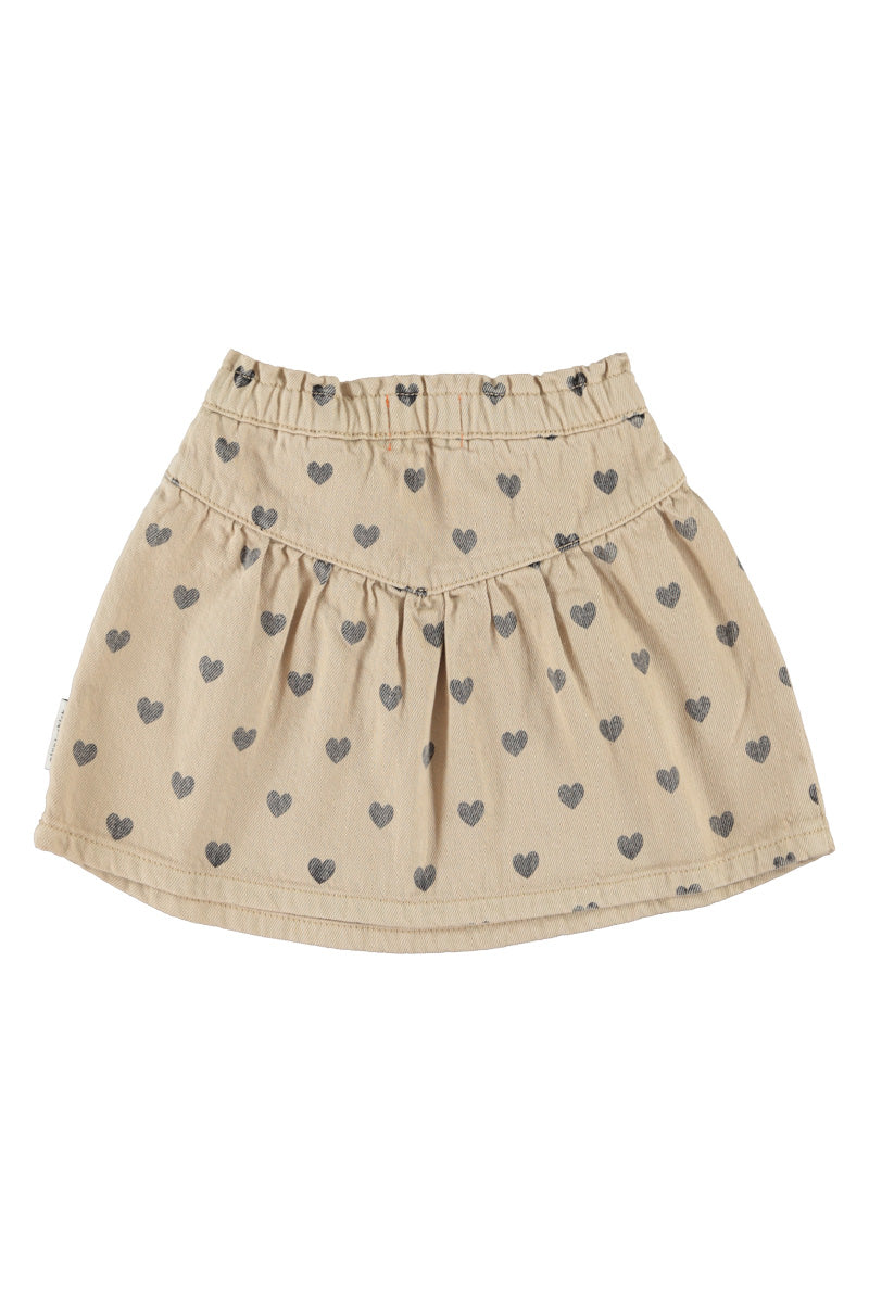 Detalle de falda de niña beige con corazones negros de piupiuchick.