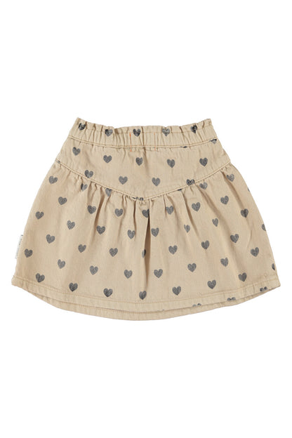 Detalle de falda de niña beige con corazones negros de piupiuchick.