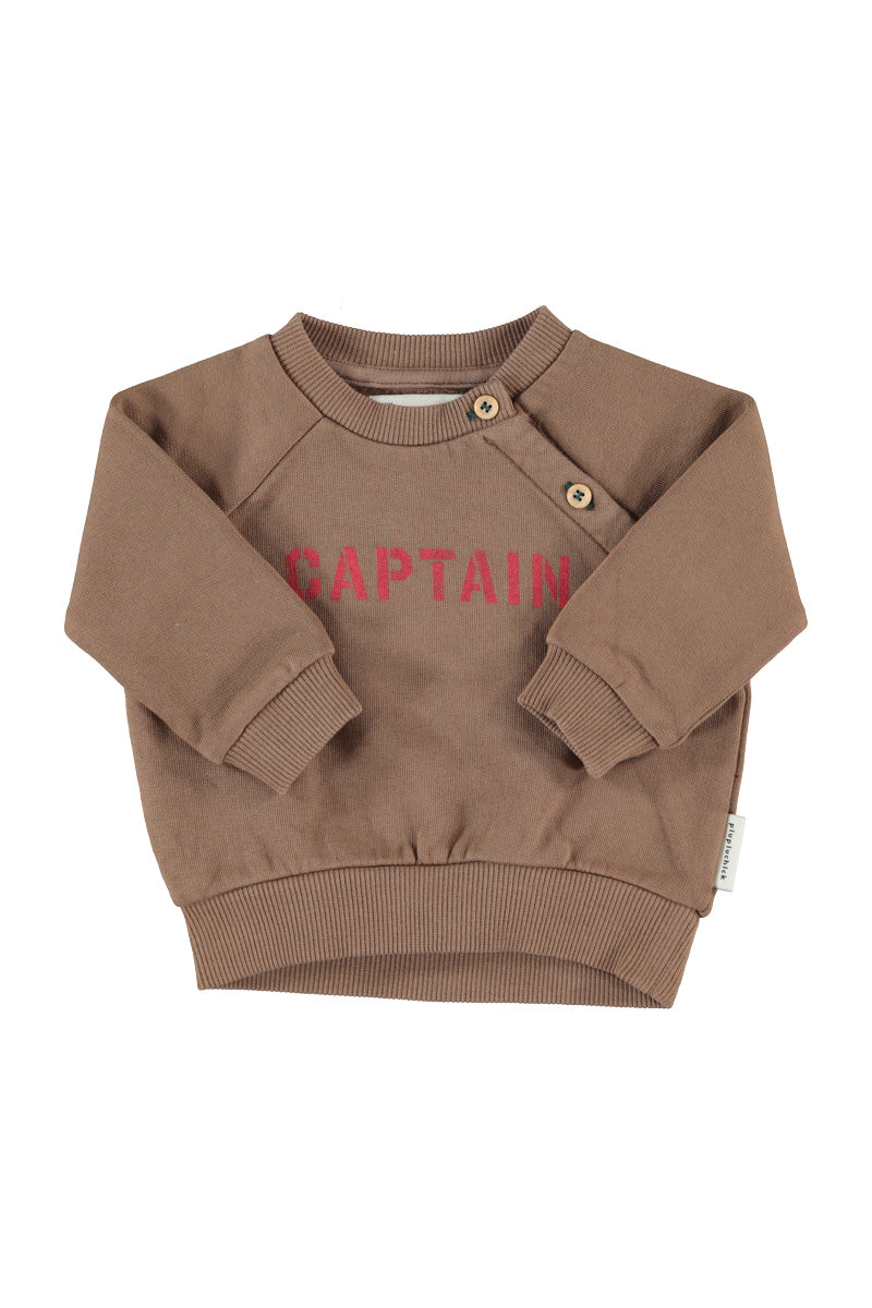 Detalle de sudadera de bebé marrón con captain de piupiuchick.