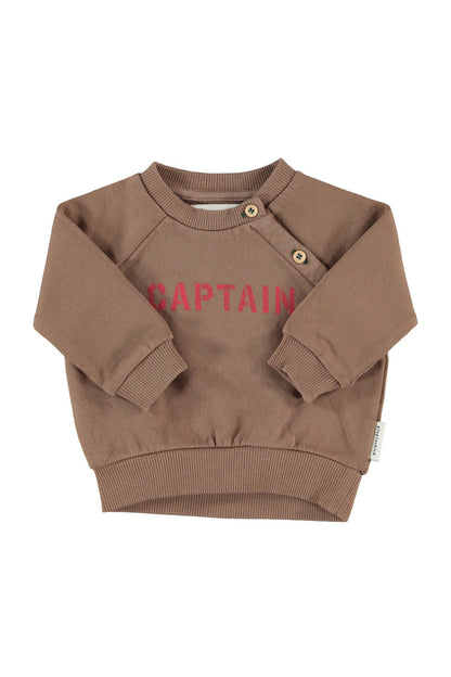 Detalle de sudadera de bebé marrón con captain de piupiuchick.