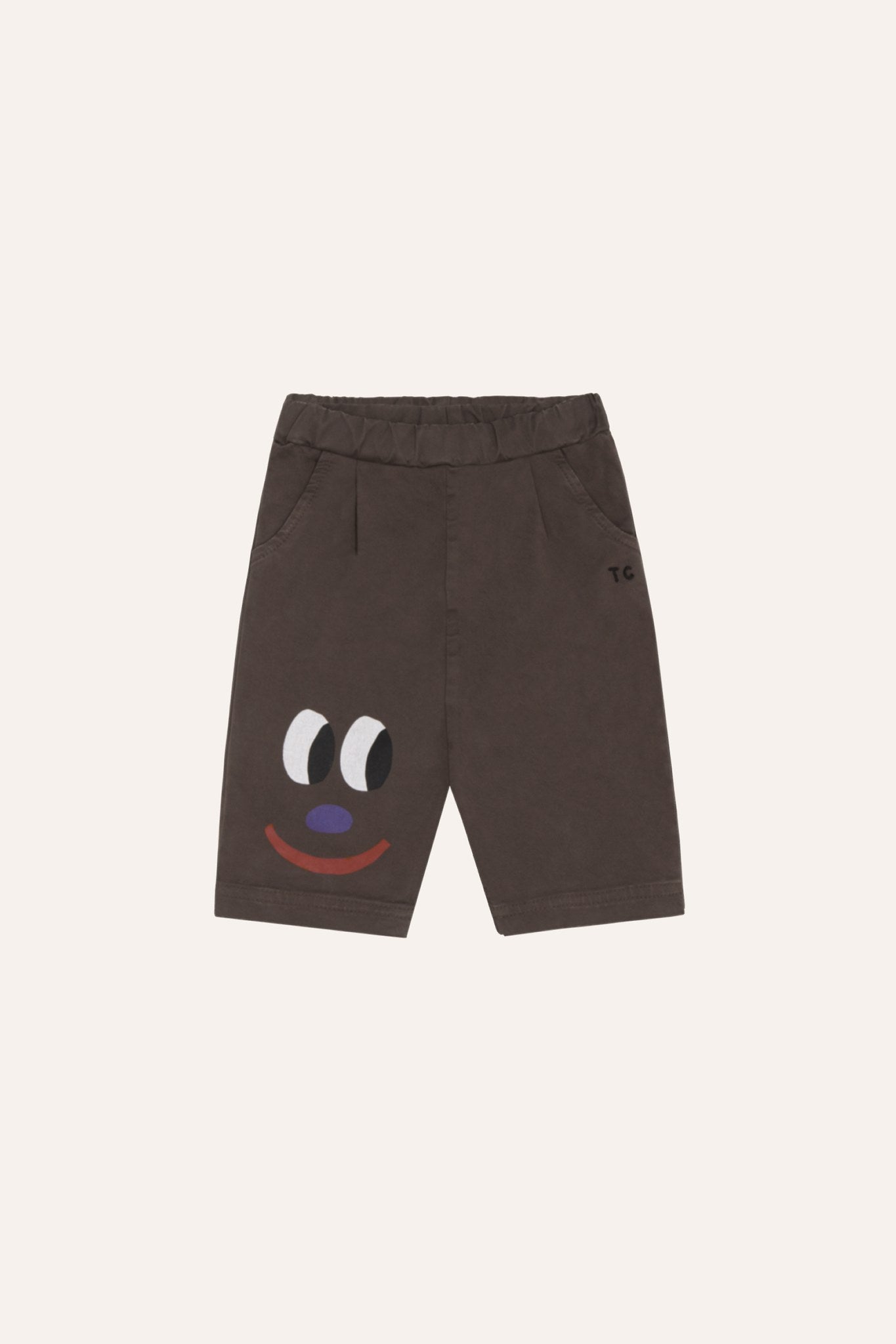 Pantalón corto de bebé marrón con cara sonriente, vista frontal.