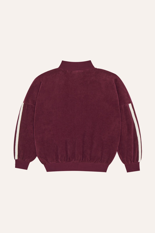Sudadera de terciopelo burdeos con bandas en las mangas, vista trasera.