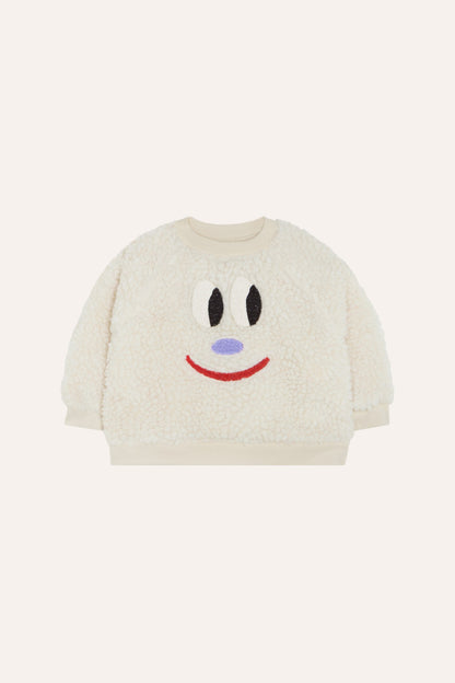 Sudadera de bebé cruda de borreguito con cara sonriente, vista frontal.