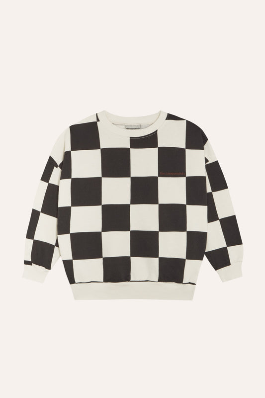 Sudadera infantil de cuadros negros y crudos, vista frontal.