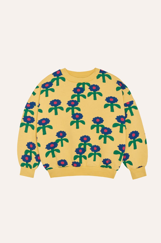 Sudadera infantil amarilla con margaritas azules, vista frontal.