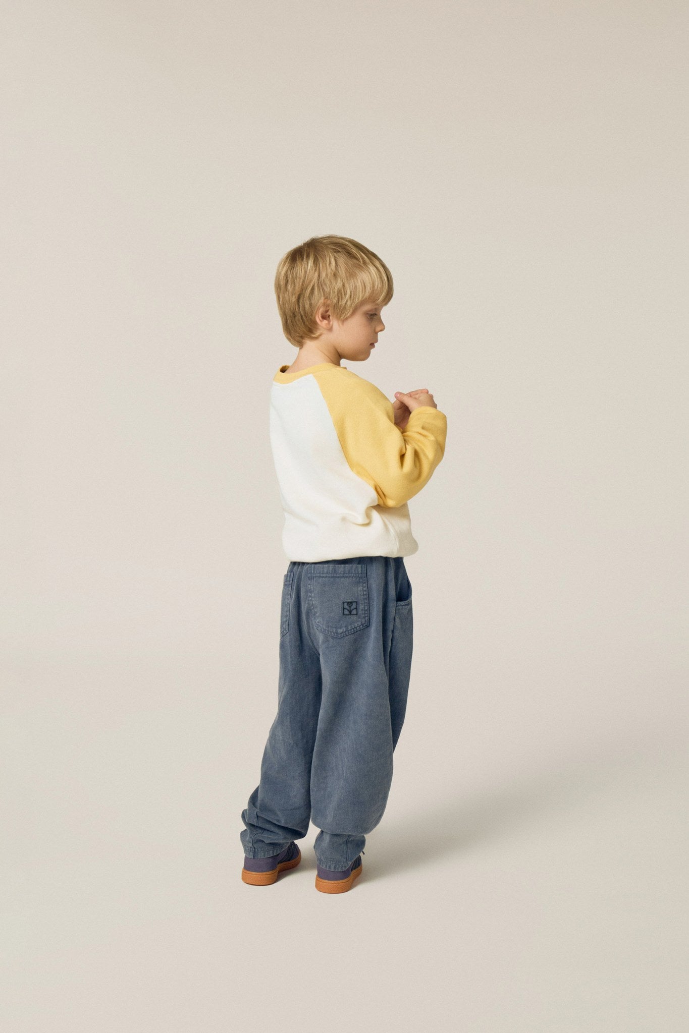 Niño de perfil con la sudadera cruda de serpiente.