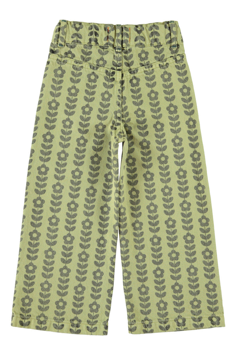 Detalle de pantalón acampanado de niña verde con flores negras de piupiuchick.