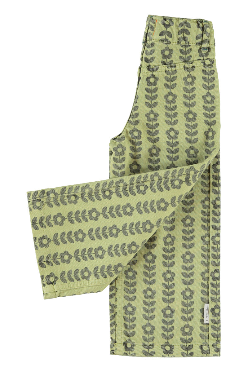 Detalle de pantalón acampanado de niña verde con flores negras de piupiuchick.