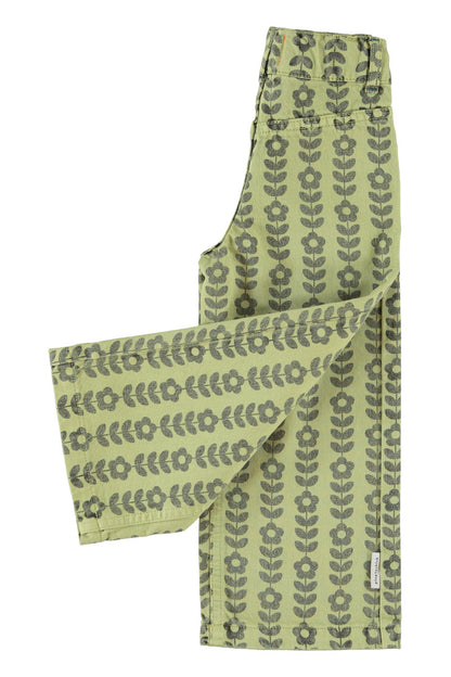 Detalle de pantalón acampanado de niña verde con flores negras de piupiuchick.